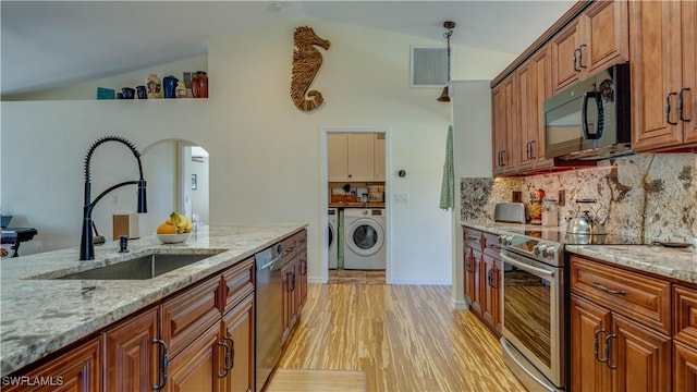 kitchen featuring dishwashing machine, visible vents, stainless steel electric range, a sink, and black microwave