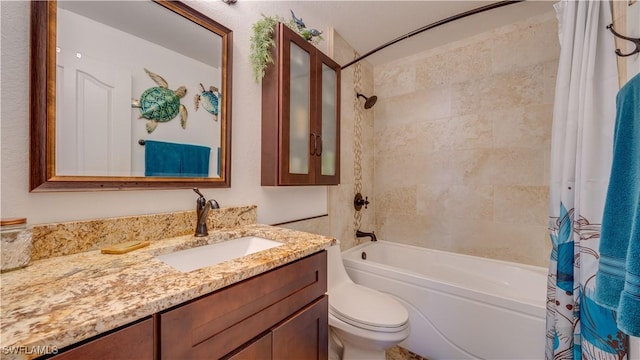 full bathroom featuring vanity, shower / bath combination with curtain, and toilet