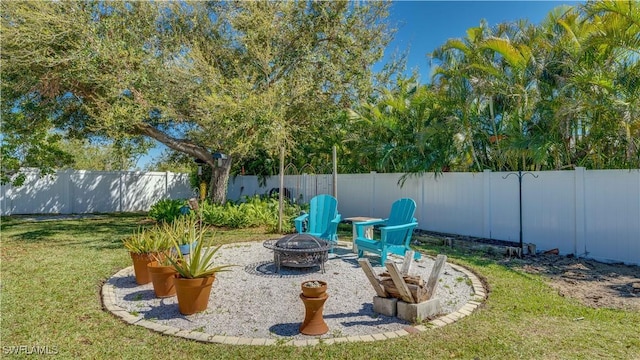 view of yard featuring a fenced backyard and an outdoor fire pit