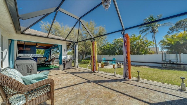 view of patio / terrace featuring glass enclosure and a fenced backyard