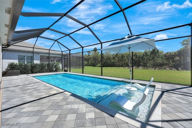 pool with a yard, a patio, and glass enclosure