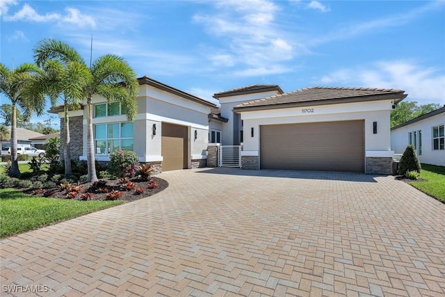 view of front of property with stone siding, stucco siding, decorative driveway, and a garage