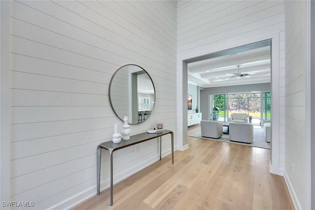 hallway with baseboards and light wood-style floors