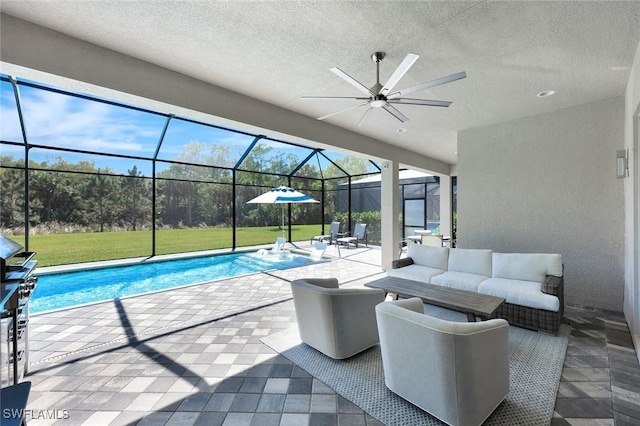 pool with a lawn, a ceiling fan, a patio, glass enclosure, and outdoor lounge area