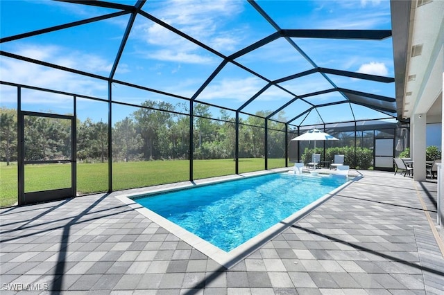 pool with glass enclosure, a patio, and a lawn