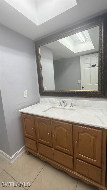 2510 SE 16th Pl Unit 103, Cape Coral, FL 33904 - bathroom featuring tile patterned floors, baseboards, and vanity