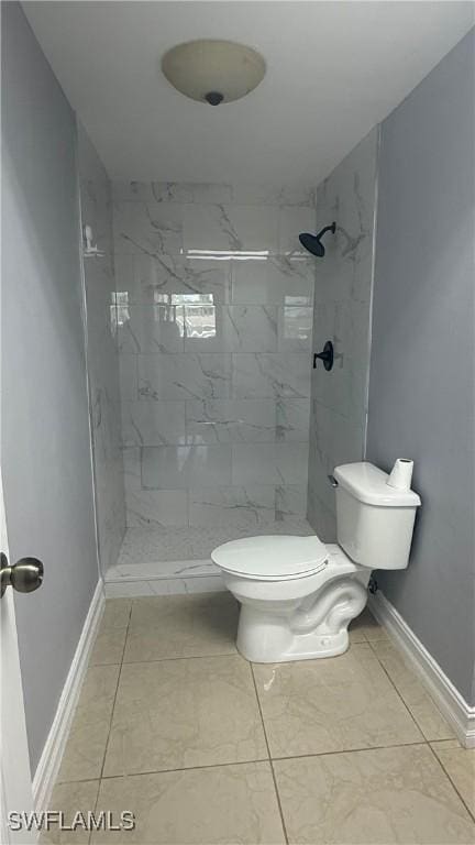 2510 SE 16th Pl Unit 103, Cape Coral, FL 33904 - bathroom featuring baseboards, toilet, marble finish floors, and a stall shower