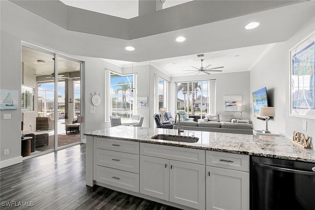 kitchen featuring a sink, dark wood finished floors, crown molding, light stone countertops, and dishwasher