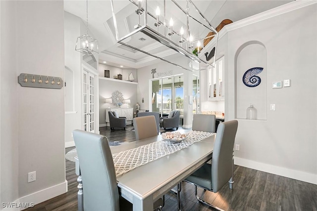 dining room featuring french doors, dark wood-type flooring, baseboards, and ornamental molding