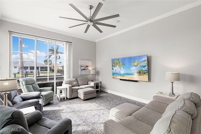 living area with a ceiling fan, baseboards, and ornamental molding