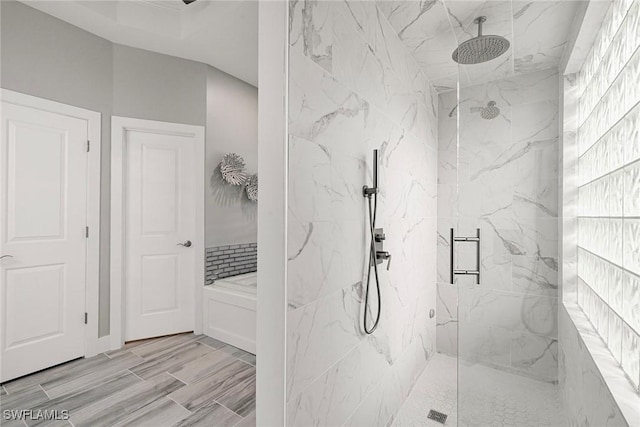 bathroom featuring a marble finish shower