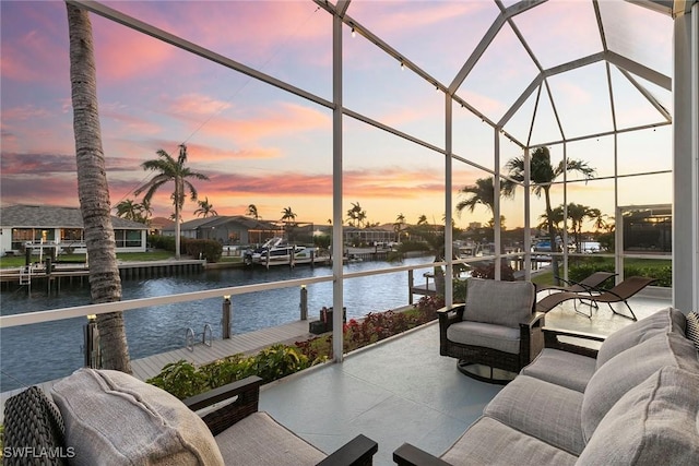 view of patio / terrace with glass enclosure and a water view