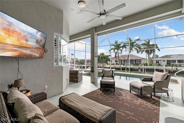 view of patio featuring ceiling fan, an outdoor pool, an outdoor living space, and a lanai