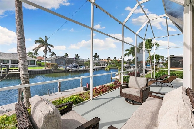 sunroom featuring a water view