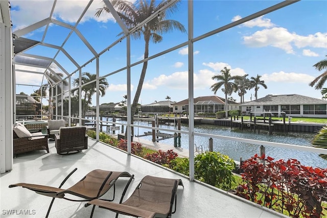 view of patio with a dock, a lanai, a water view, and a residential view