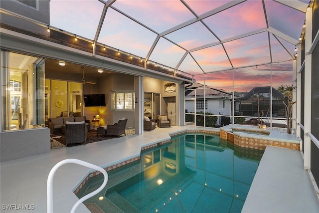 view of pool featuring a patio area, an outdoor living space, a pool with connected hot tub, and a lanai