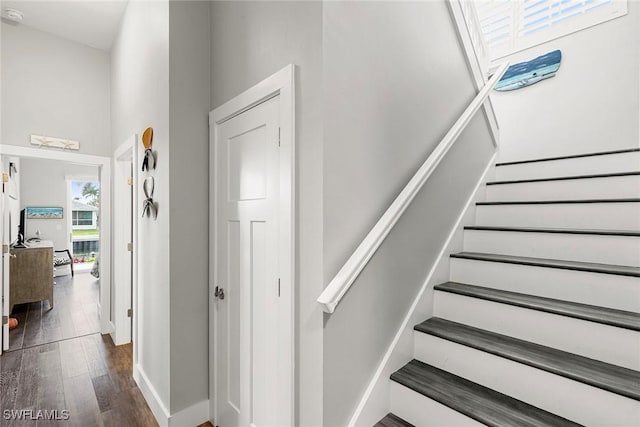 stairway featuring wood finished floors and baseboards