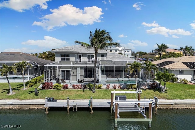 back of house with an outdoor pool, a yard, a water view, and a lanai