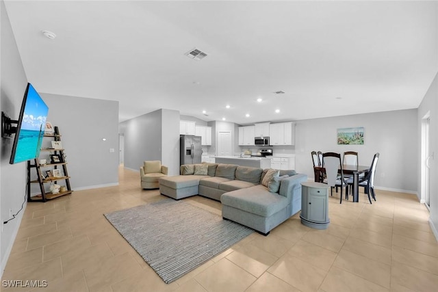 living area featuring light tile patterned floors, visible vents, recessed lighting, and baseboards