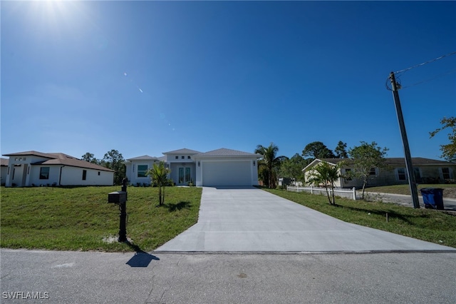 view of front of property with driveway, an attached garage, and a front lawn