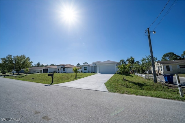 view of front of property featuring a garage, a residential view, concrete driveway, and a front yard