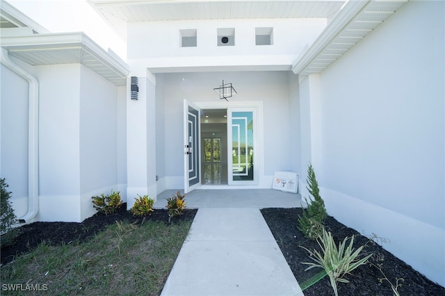 entrance to property featuring stucco siding