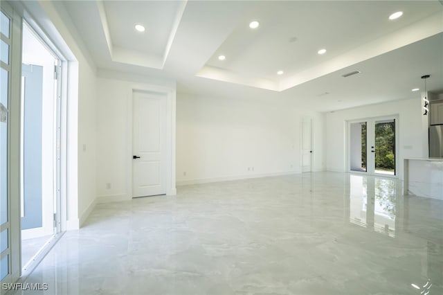 unfurnished room with visible vents, recessed lighting, marble finish floor, and a tray ceiling