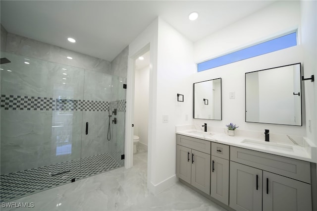 full bath featuring marble finish floor, toilet, a shower stall, and a sink