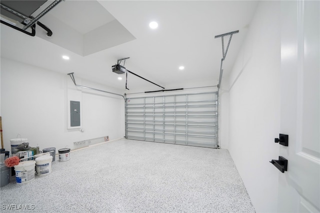 garage featuring electric panel, recessed lighting, and a garage door opener