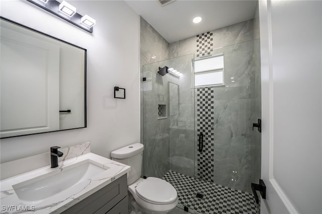 full bathroom with visible vents, a shower stall, toilet, and vanity