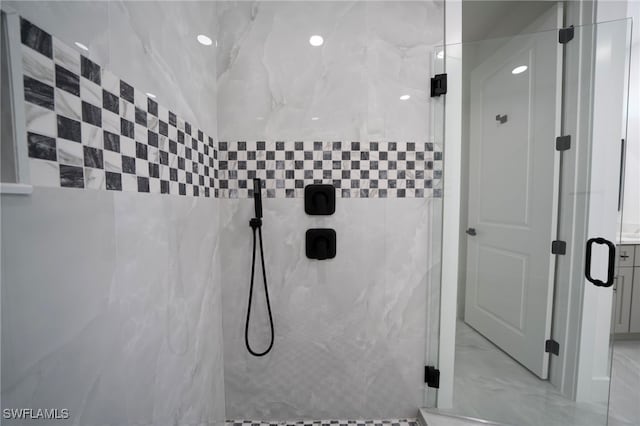 bathroom featuring a marble finish shower and marble finish floor