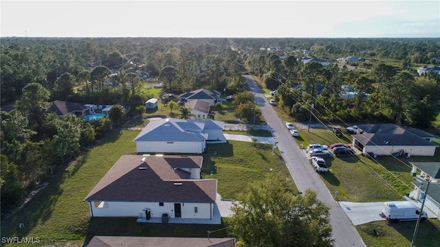 drone / aerial view featuring a view of trees