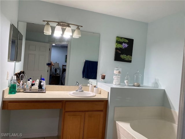 ensuite bathroom featuring vanity, ensuite bathroom, and a garden tub