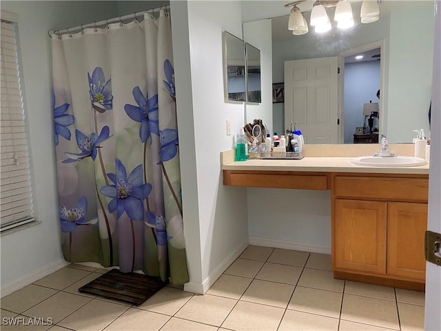 bathroom featuring a shower with shower curtain, baseboards, vanity, and tile patterned flooring