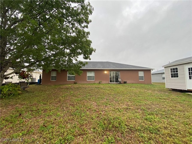 rear view of house with a yard