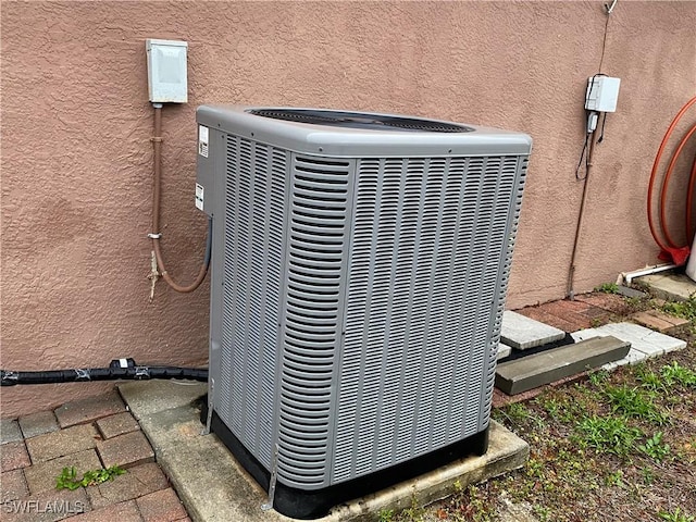 exterior details featuring central air condition unit and stucco siding