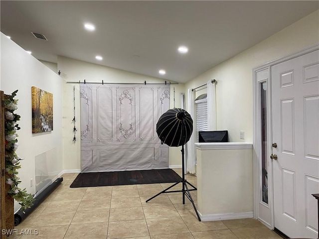 tiled foyer featuring visible vents, recessed lighting, baseboards, and lofted ceiling