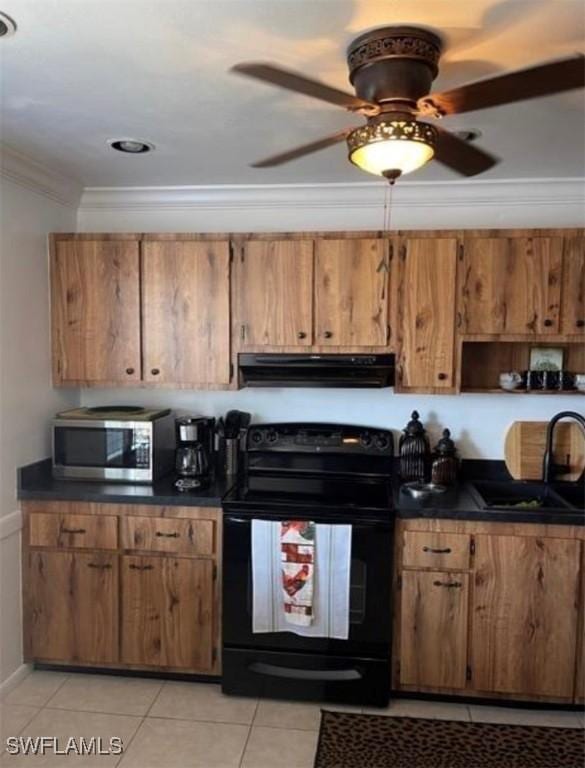 kitchen with black electric range, stainless steel microwave, a sink, dark countertops, and exhaust hood