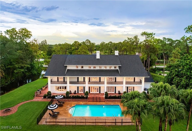 13189 Valewood Dr, Naples, FL 34119 - rear view of house with a balcony, a patio, a chimney, stucco siding, and an outdoor pool