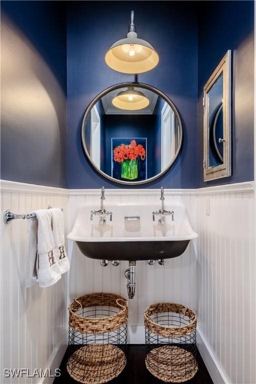 13189 Valewood Dr, Naples, FL 34119 - bathroom with a wainscoted wall and a decorative wall
