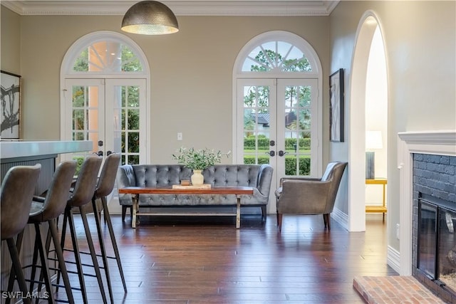 13189 Valewood Dr, Naples, FL 34119 - dining room with french doors, ornamental molding, dark wood-type flooring, and a fireplace