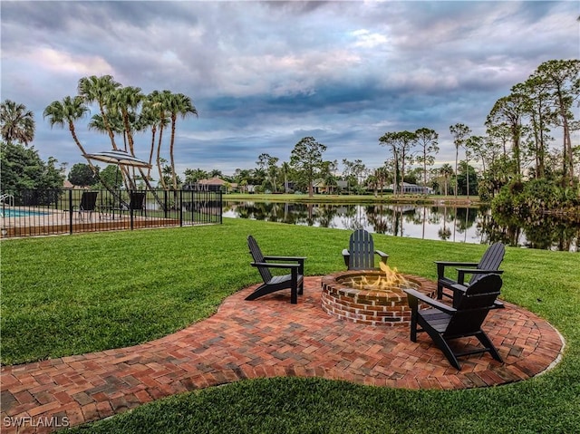 13189 Valewood Dr, Naples, FL 34119 - view of patio / terrace with a fire pit and a water view
