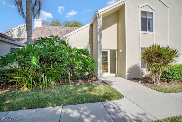 entrance to property featuring stucco siding