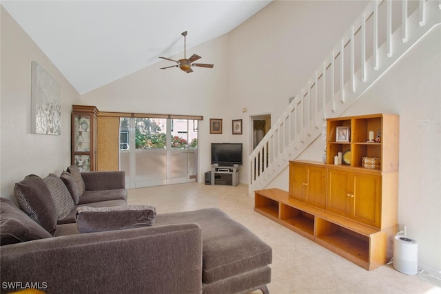 tiled living area featuring high vaulted ceiling, stairs, and a ceiling fan