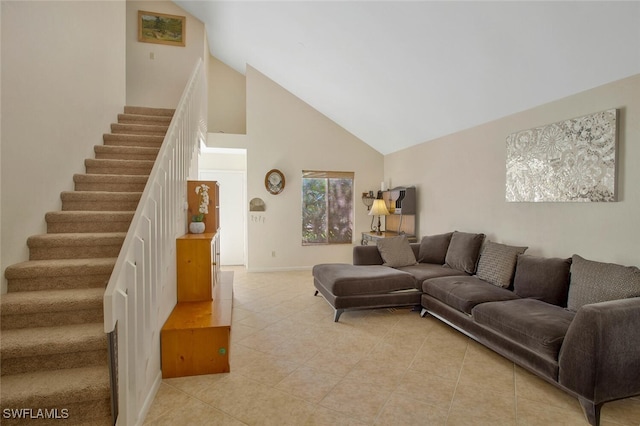 living room featuring light tile patterned floors, high vaulted ceiling, and stairs