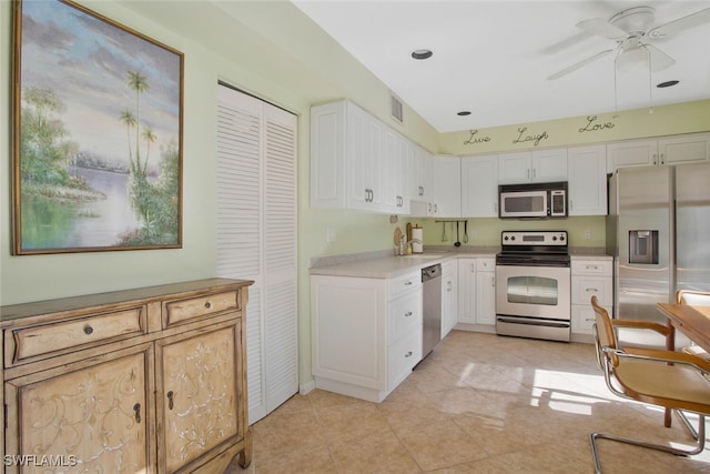 kitchen featuring a ceiling fan, visible vents, stainless steel appliances, light countertops, and white cabinetry