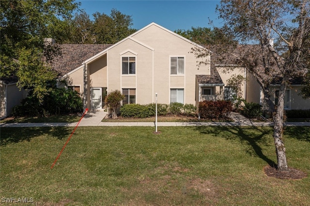 view of front of property with stucco siding and a front yard