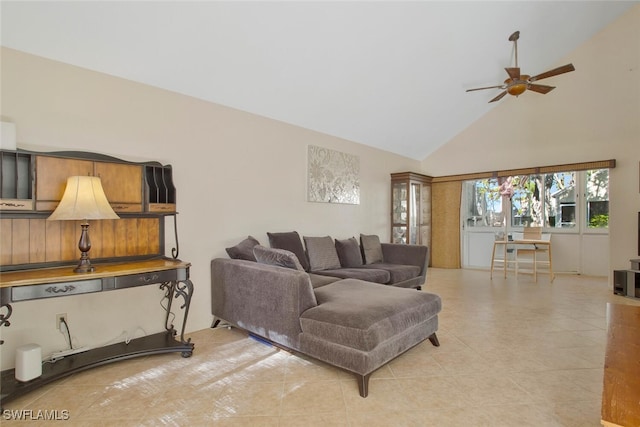 living area with light tile patterned floors, a ceiling fan, and high vaulted ceiling