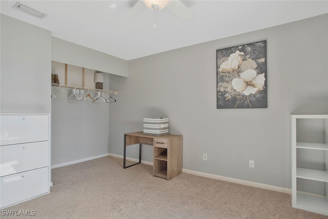 interior space with visible vents, baseboards, carpet floors, and ceiling fan