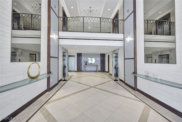 hall featuring baseboards and a notable chandelier